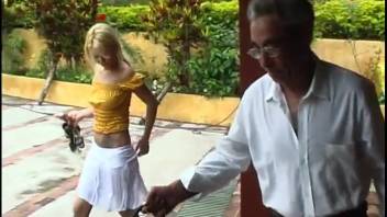 Blonde in white skirt performs oral on a dog before this guy